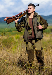 Hunting weapon gun or rifle. Man hunter carry rifle nature background. Experience and practice lends success hunting. Guy hunting nature environment. Masculine hobby activity. Hunting season