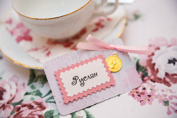 cup of coffee and flowers on wooden table