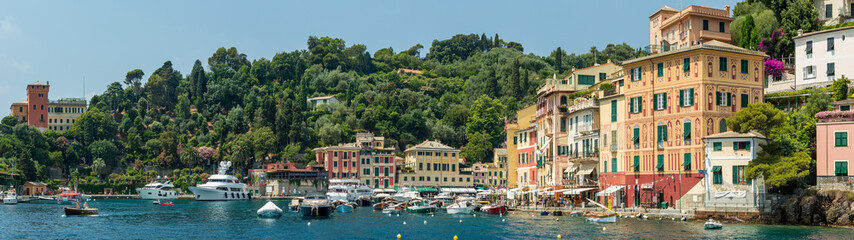 Fototapeta na wymiar Panoramic view of the buildings overlooking the beautiful harbour at Portofino on the Ligurian coast, Italy