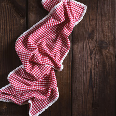 red textile towel in a white cell on a brown wooden  background