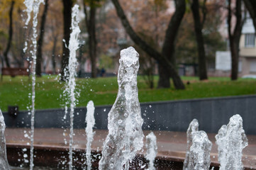 Many water streams, water splashes and drops in the fountain. Abstract background of water trickles...