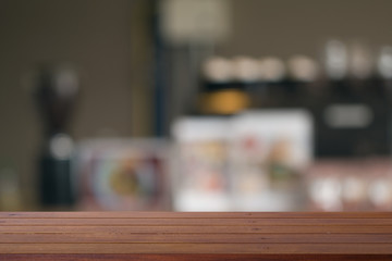 Wooden desk with Blurred of coffe's shop for abstract background