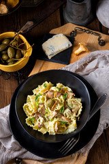 Reginette noodles in cream sauce with fresh chanterelles and capers