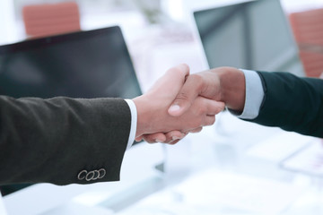 handshake financial partners over a Desk in the office