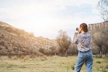 Back view Asian woman using camera  taking photo for landscape view photography