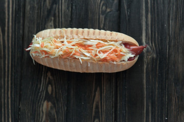 hot dog with vegetables on wooden background.photo with copy spa