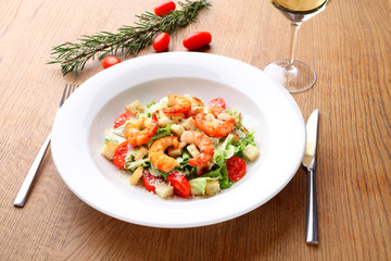 The best fresh salad of prawns in the white dish. Caesar salad with fried shrimps, tomatoes, cheese, lettuce. Healthy food concept. - Stock image