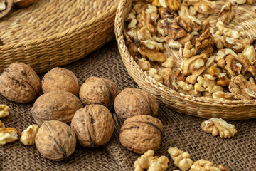 Walnuts on rustic natural burlap, Walnut kernels in wicker basket, Walnut background