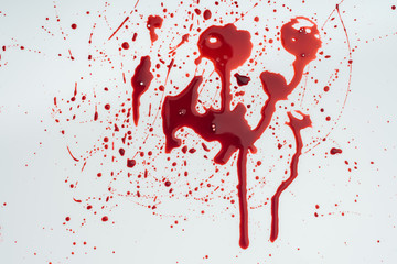 close-up shot of messy blood splashes on white tabletop