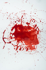 top view of messy blood blot on white surface