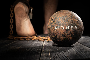 Money are ball on the leg. Concept of fear. - 233368407