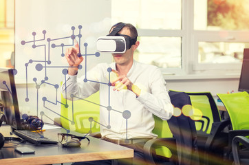 Man with glasses of virtual reality is engaged modern visual technology in business. Designer, web engineer.