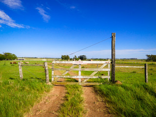 Entrance of a rural property with a sign written in Portuguese "Forbidden the entrance of strange (unauthorized) people" - Uruguaiana, Brazil
