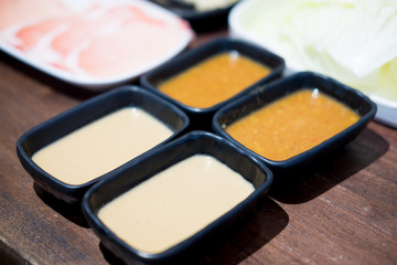 Close up of dipping in spicy sauce at restaurant