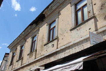 Fototapeta na wymiar Exterior of destroyed building against cloudy sky