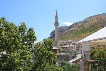 The historic town of Mostar, spanning a deep valley of the Neretva River, developed in the 15th and...
