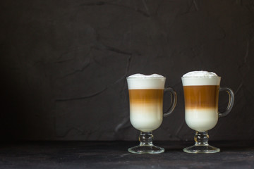 Latte - coffee with milk in a transparent cup on the table. Top view.