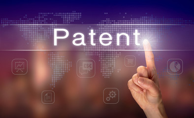 A hand selecting a Patent business concept on a clear screen with a colorful blurred background.