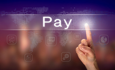 Fototapeta premium A hand selecting a Pay business concept on a clear screen with a colorful blurred background.