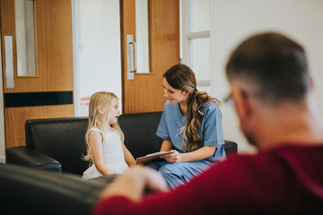 Young girl speaking to a female nurse