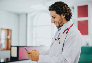 Male doctor using his smartphone