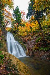 Waterfall among many foliage, In the fall leaves Leaf color change In Yamagata, Japan