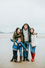 Fototapeta na wymiar Cheerful family portrait at the beach