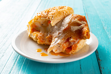 side view studio shot of bread with chicken with the last bit