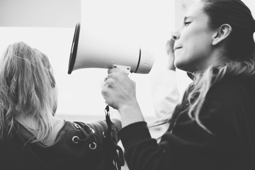 Female activist shouting on a megaphone