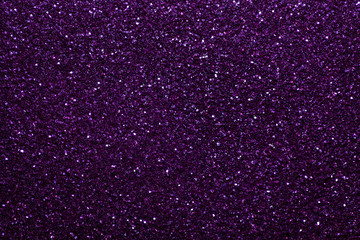 Dark purple sparkling background from small sequins, closeup. Brilliant backdrop.