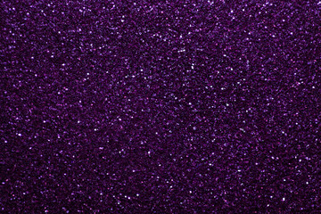 Dark purple sparkling background from small sequins, closeup. Brilliant backdrop.