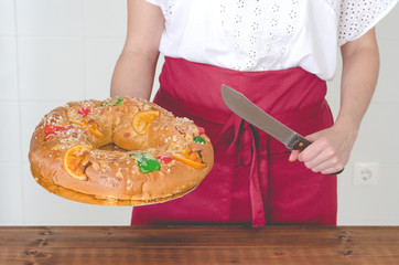 Female waitress showing Kings Cake.