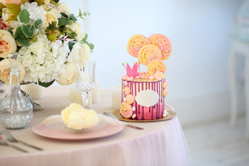 pink cake for little Princess with crown and yellow marshmallows. © oksnemova