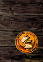 Whiskey or whisky in rocks glass on from top view isolated on wooden table background