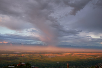 Fototapeta premium Bird eye on view on Alazani valley, clouds in the sky sunset