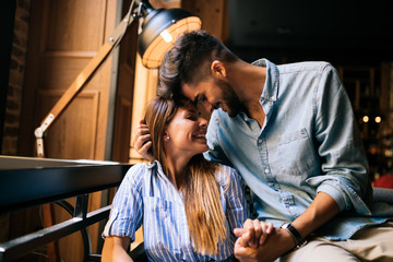 Young attractive couple on date in coffee shop