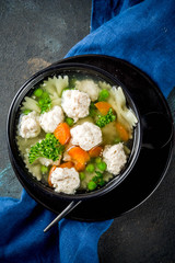 Healthy food, diet lunch. Soup with meatballs, fresh vegetables and greens.