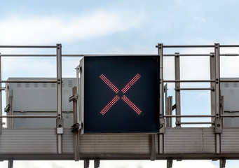 Sign with a red cross lit