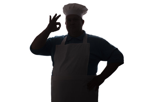 silhouette of a happy chef on a white isolated background, male hand shows ok, food industry concept