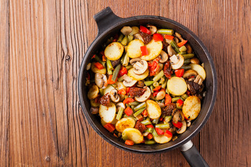Fried pan vegetables, with mushrooms and dried tomatoes. Seasoned with a mix of herbs.