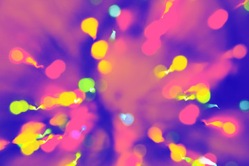 Obraz na płótnie Canvas Multicolored festive lights on blue and purple background.