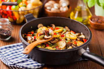 Fried pan vegetables, with mushrooms and dried tomatoes. Seasoned with a mix of herbs.