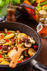 Fried pan vegetables, with mushrooms and dried tomatoes. Seasoned with a mix of herbs.