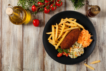 Chicken Kiev (de Volaille chop) with french fries and salads.