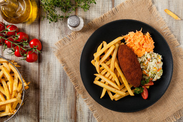 Chicken Kiev (de Volaille chop) with french fries and salads.