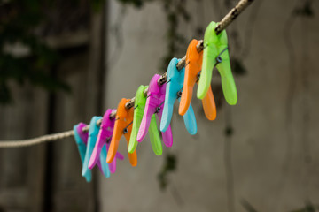 soft focus plastic colorful empty pins to dry clothes hanging on string on back yard environment space 