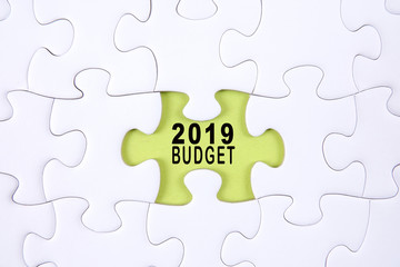 Fototapeta premium Business concept: 2019 BUDGET word on a jigsaw puzzle background.
