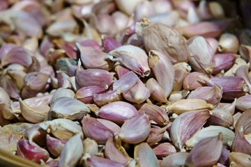White garlic pile texture. Fresh garlic on market table closeup photo