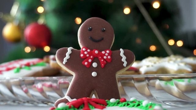 Gingerbread Man cookie in front of a Christmas Tree