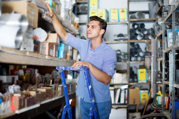 Male in unifom is standing on ladder